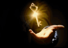 a hand is holding a key that is lit up