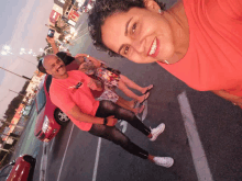 a man wearing a red shirt that says nike is standing next to a woman