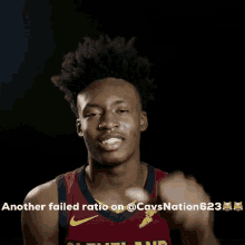 a man in a cleveland cavs jersey points at the camera