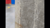 a close up of a concrete wall with a red arrow pointing to the right .