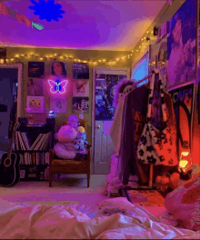 a bedroom with a neon butterfly on the wall and a guitar