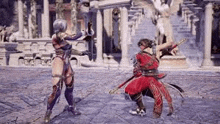 a man and a woman are fighting in a video game in a courtyard .