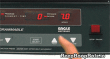 a person is pressing a button on a eagle electronic treadmill