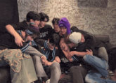 a group of young men are hugging each other and one of them is wearing a shirt that says get your kicks on it