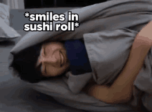 a man wrapped in a blanket with the words " smiles in sushi roll " on the bottom