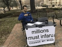 a man sitting at a table with a sign that says millions must infaru