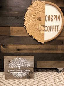 a wooden sign that says caspin coffee next to a wooden wall