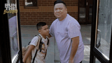 a man and a boy are standing in front of a building with the words run the burbs on the wall