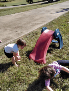 a little tikes slide is being played with by two young girls