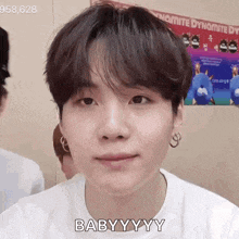 a close up of a person 's face with the words `` baby yyy '' written on it .