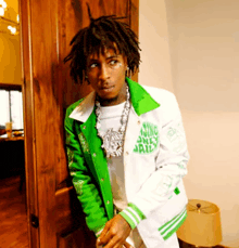 a young man wearing a green and white jacket that says " using only jail "