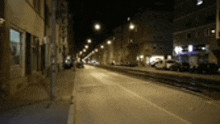 a blurred image of a city street at night with a lot of lights on .