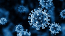 a close up of a virus under a microscope on a blue background .