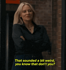 a woman stands in front of a brick wall with the words that sounded a bit weird you know that don t you