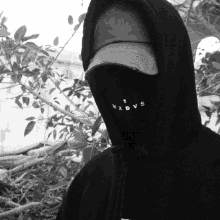 a person wearing a black hoodie with the letters mxdvs on the front