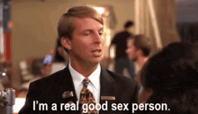 a man in a suit and tie is talking to a woman .