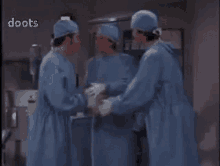 a group of surgeons are standing in an operating room with the word doots visible in the corner