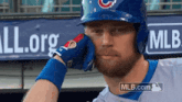 a baseball player wearing a helmet and gloves with mlb.com written on the bottom right