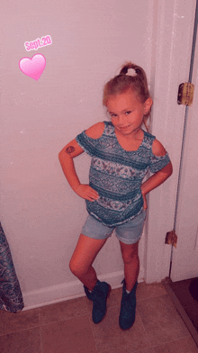 a little girl standing in front of a door with the date september 20 on the bottom right