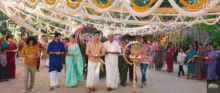 a group of people holding candles in front of an elephant and a sign that says ' a ' on it