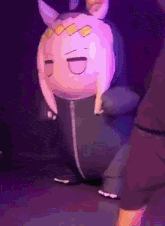 a stuffed animal that looks like a rabbit with horns is dancing on a stage