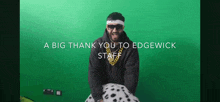 a man in a dalmatian costume says " a big thank you to edgewick staff " in front of a green screen