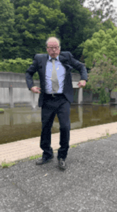 a man in a suit and tie is dancing