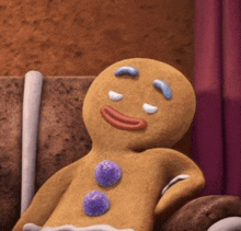 a gingerbread man is laying on a chair with his eyes closed and smiling