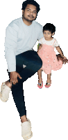 a man kneeling down holding a little girl in his arms