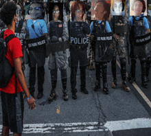 a group of people wearing us park police shields stand on a street