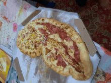 a pizza in a box with a toothpick sticking out