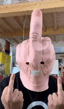 a man wearing a mask with a middle finger on his face