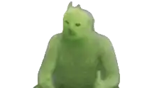a green cat with horns is standing on a white surface .
