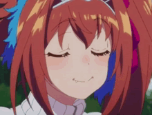 a close up of a girl 's face with her eyes closed .