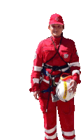 a woman in a red uniform is holding a helmet that says " safety first "