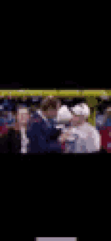 a blurry picture of a man shaking hands with another man