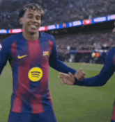 two soccer players wearing nike jerseys are dancing
