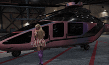 a woman in a pink dress stands in front of a pink helicopter