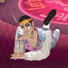 a man is laying on his stomach on the floor wearing a feather headband and eye patch .