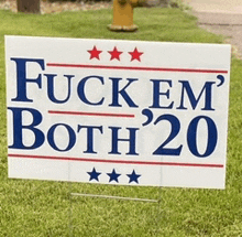 a sign that says " fuck em both 20 " is in the grass