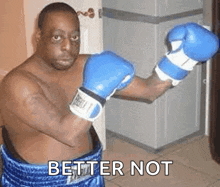 a shirtless man wearing blue boxing gloves with the words better not written below him