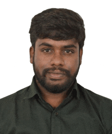 a man with a beard wearing a black shirt looks at the camera