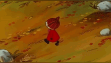 a little girl in a red coat is walking through a field of tall grass .