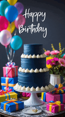 a blue birthday cake with white frosting is on a table surrounded by presents and balloons