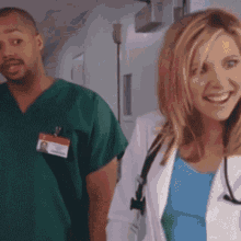 a man and a woman are walking down a hallway and the woman has a name tag that says ' a ' on it