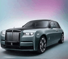 a gray rolls royce car with a black top