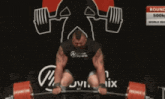 a man lifting a barbell in front of a sign that says round 3