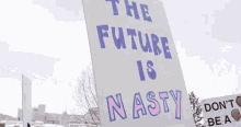 a sign that says the future is nasty in purple letters