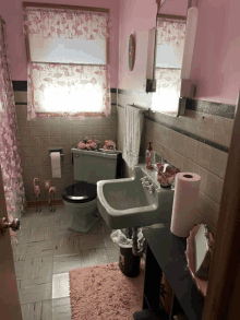 a bathroom with pink flamingos on the curtains and flamingos on the toilet