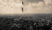 a black and white photo of a city with a helicopter flying overhead